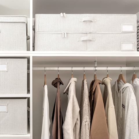 StorageWorks under-bed bin with label holder keeps seasonal clothing organized.