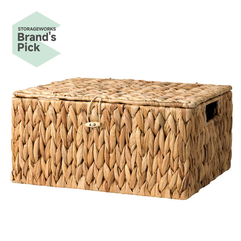 StorageWorks wicker basket with lid used to organize towels in bathroom.