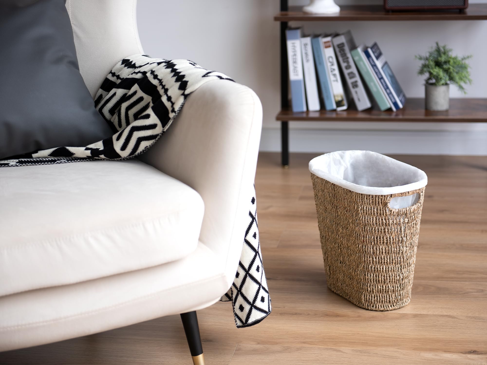 StorageWorks wicker waste basket in a bedroom for organized storage.
