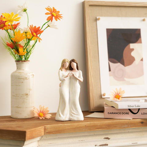 Storieme sister figurine with finger-heart gesture expresses lasting friendship.