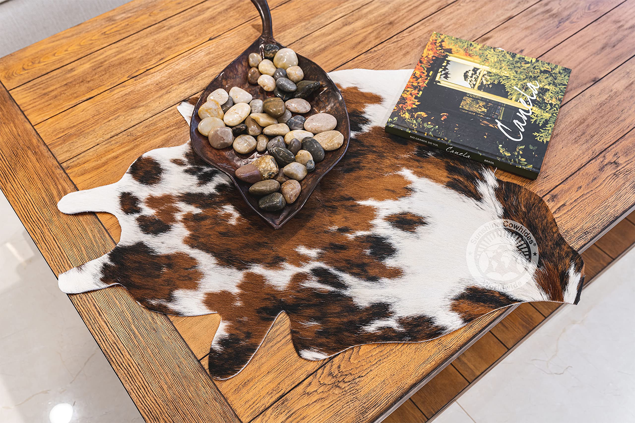 Sunshine Cowhides mini rug edge shot shows sturdy border for durable daily use.