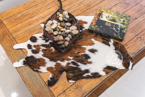 Sunshine Cowhides mini rug edge shot shows sturdy border for durable daily use.