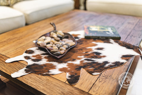 Sunshine Cowhides living room setup demonstrates versatile decor that anchors a modern space.