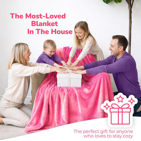Person lounging on a couch wearing the Super Blanky wearable blanket.