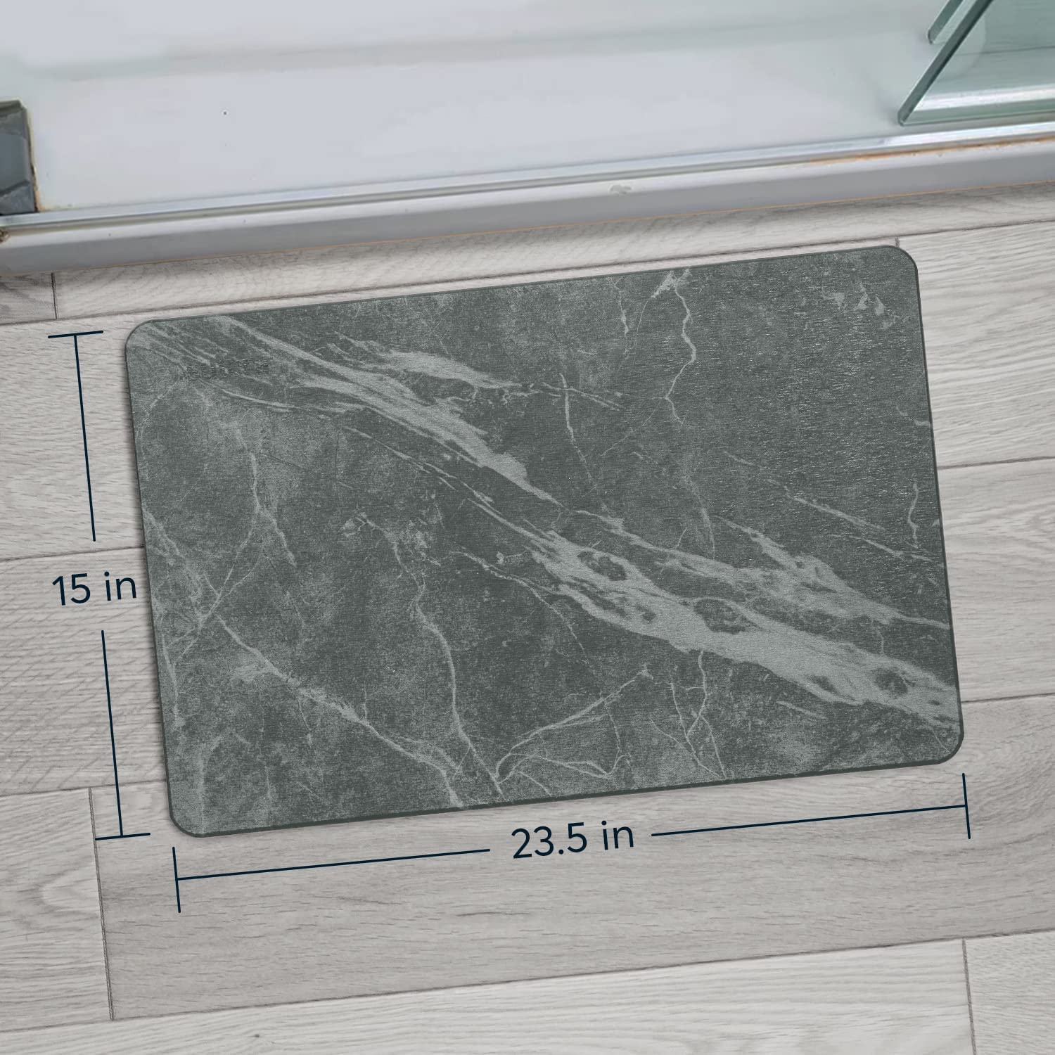 SUTERA Stone Bath Mat placed by shower for quick drying after use.