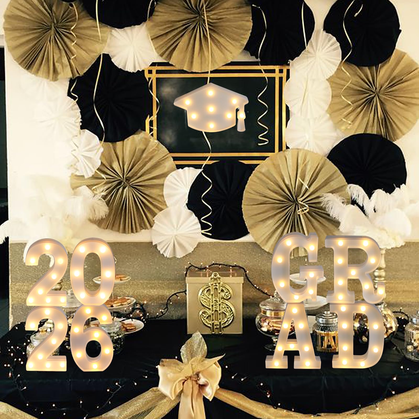 Suyeah Grad 2026 letters illuminated on a backdrop for celebrations.