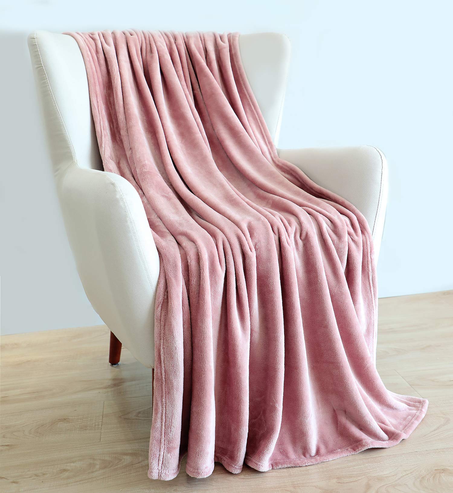 TASTHROW 60x80 blanket draped over bed for all-season warmth
