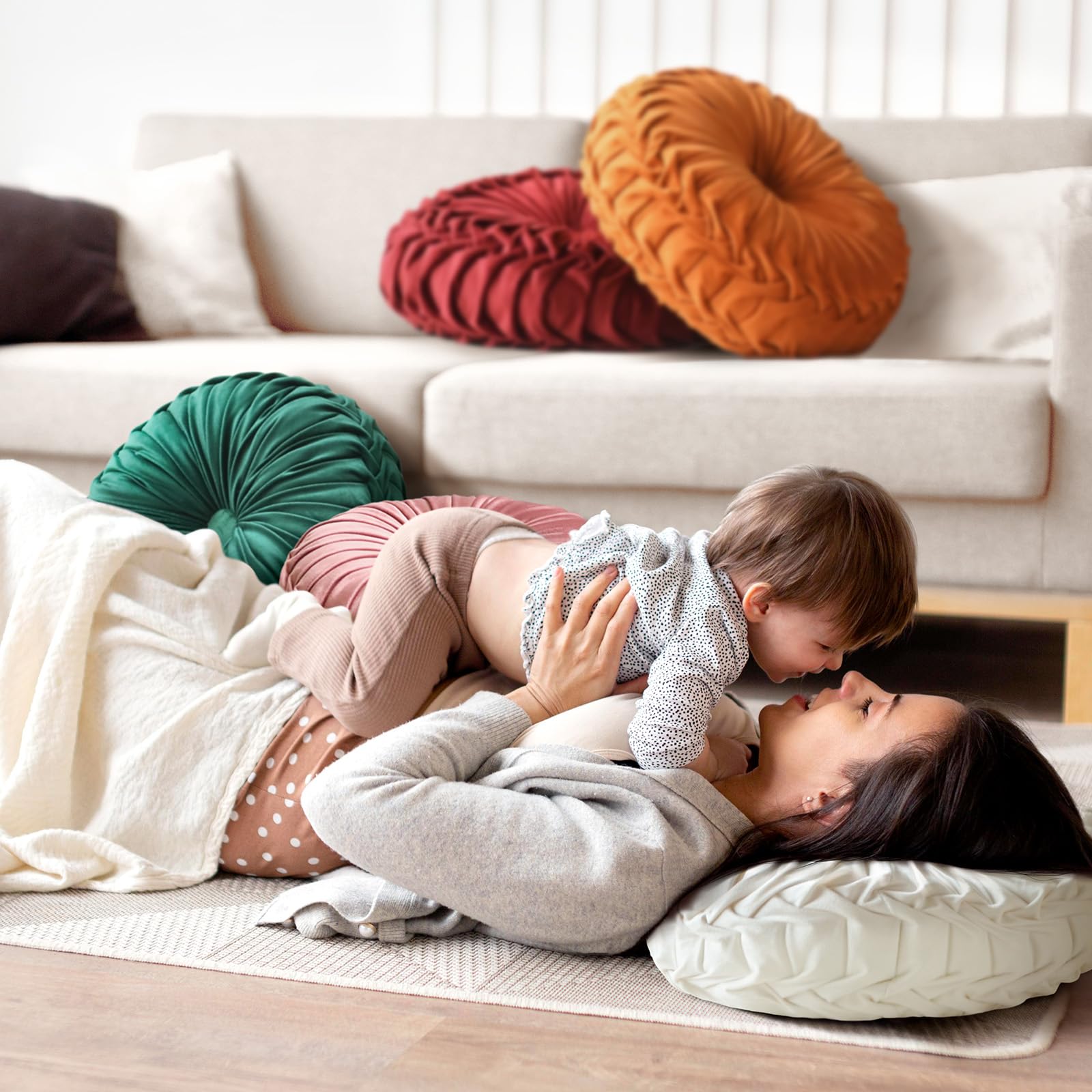 Close-up shows pleated button detailing on Teieas round pillow for classic style.