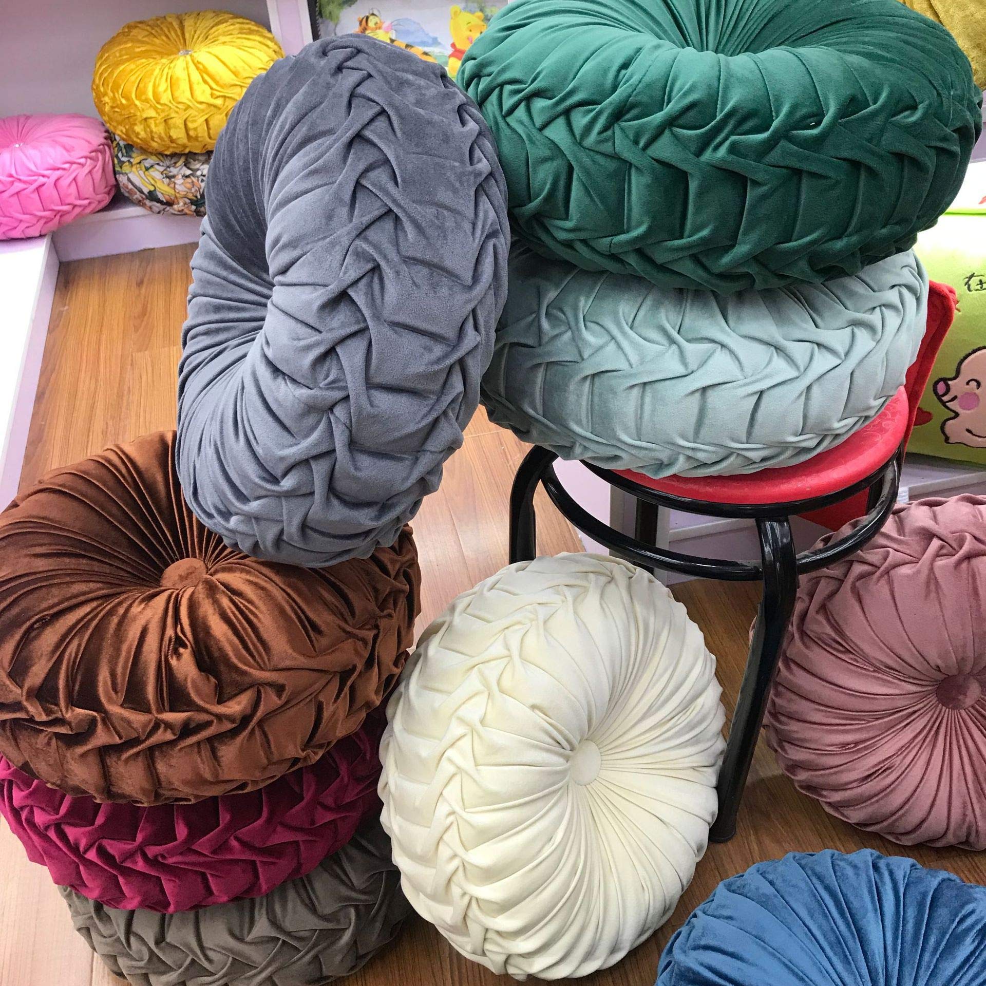 Teieas pillow detail highlights pleats and button, elevating any chair or couch