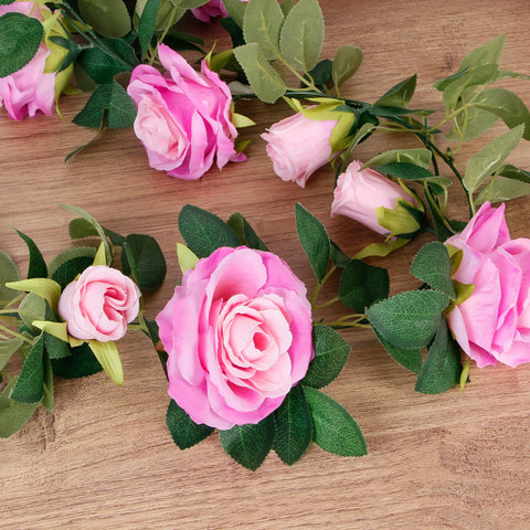 TELDRASSIL rose vine centerpiece brightens tables with vivid purplish-red blooms.