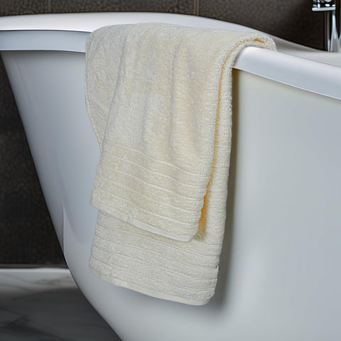 Tens Towels bath sheet cream draped on bed highlights luxurious size
