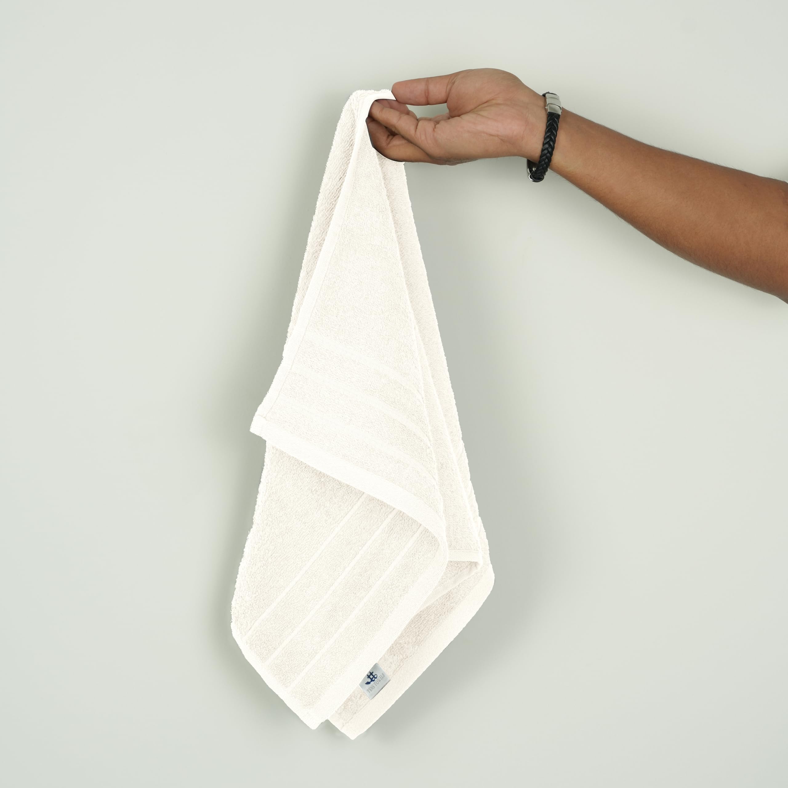 Cream-colored Tens Towels arranged in neat six-pack display