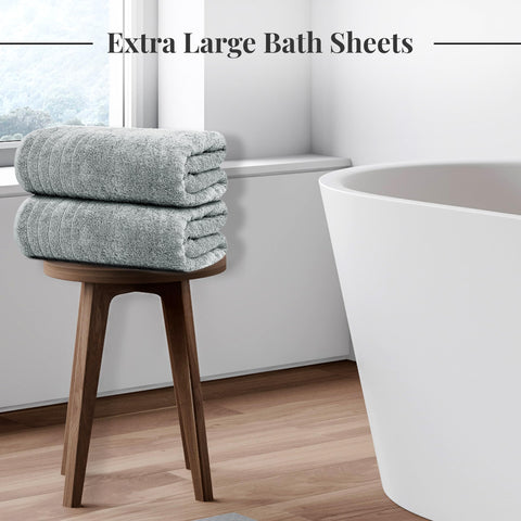 Tens Towels oversized bath sheet draped around a person after a shower for full coverage.