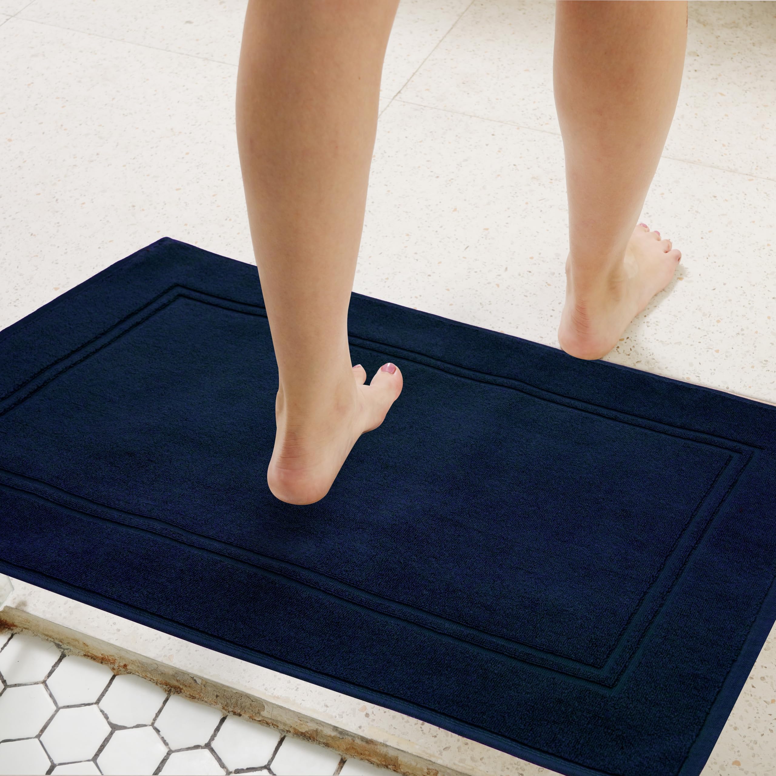 Tens Towels quick-dry navy bath mat reduces dampness between uses.