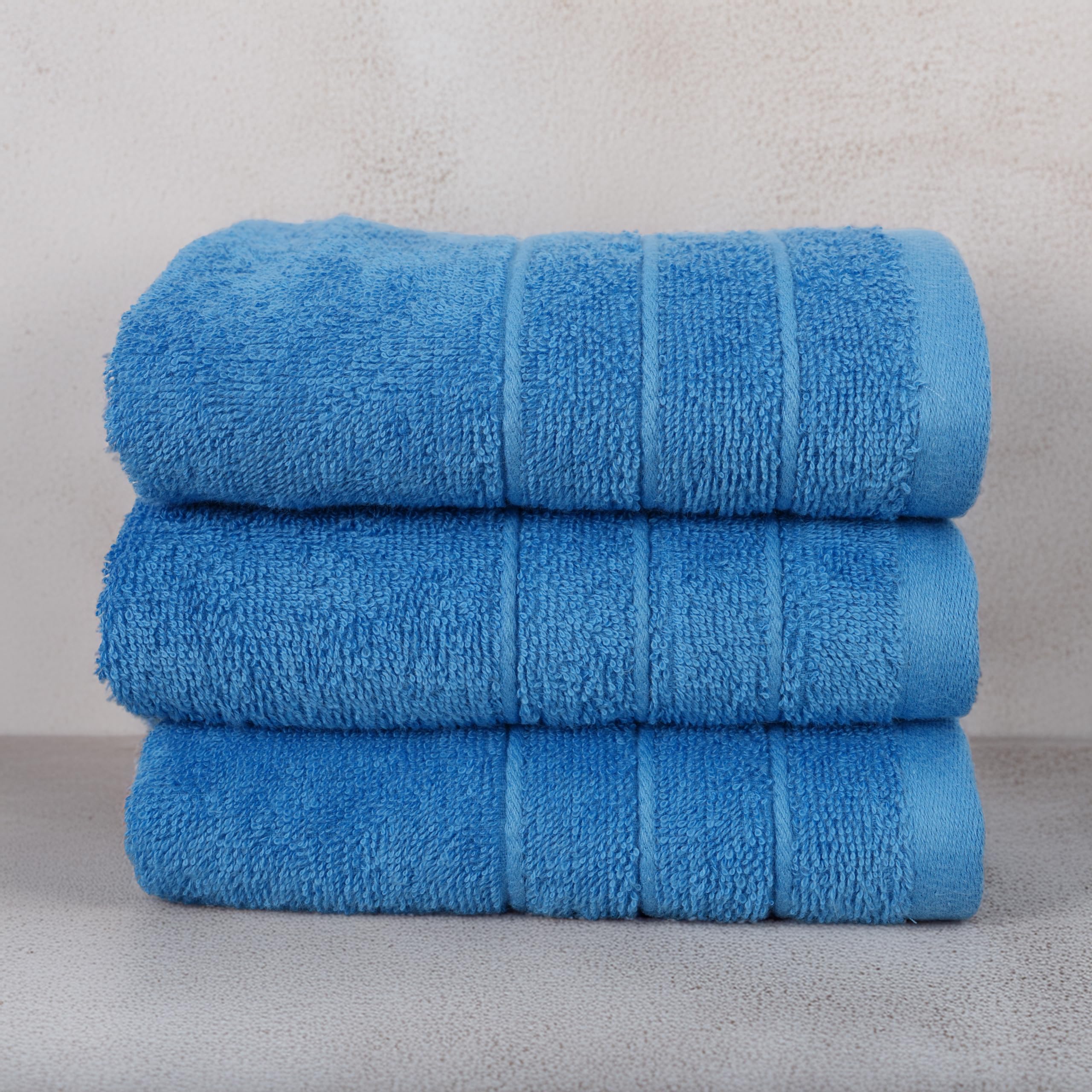 Tens Towels soft-touch-blue-towel-fabric close-up highlights plush feel.