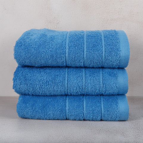 Tens Towels soft-touch-blue-towel-fabric close-up highlights plush feel.