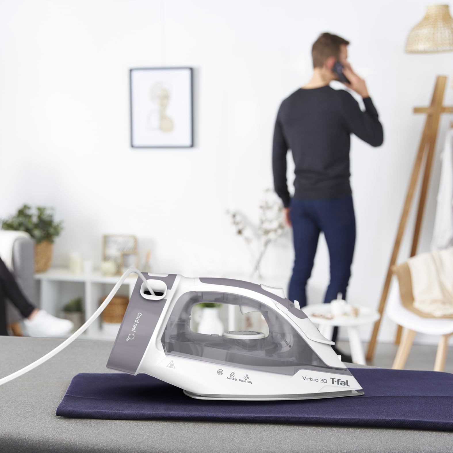 T-Fal Virtuo Steam Iron in use on shirts demonstrates quick wrinkle removal.