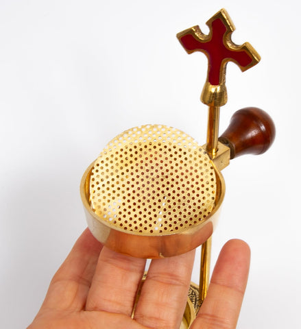 Stable heat-safe base reduces risk during worship and reflections.