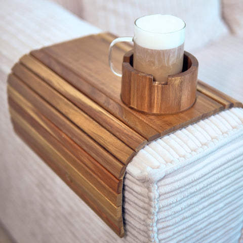 The Lazy Store Acacia couch arm tray on a sofa arm for easy snacking.