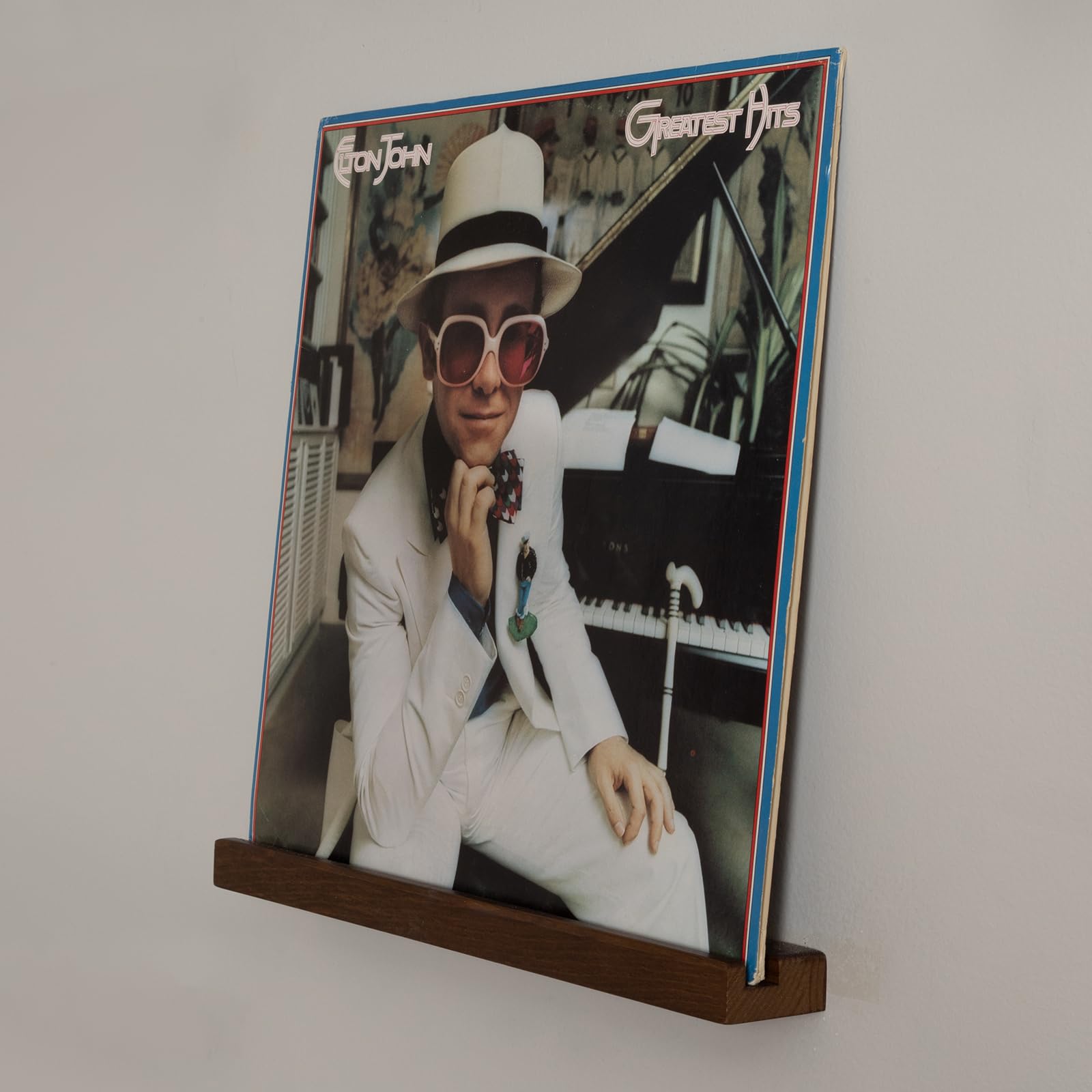 The Retro Apothecary wall-mounted vinyl collection shelf blends function with style.