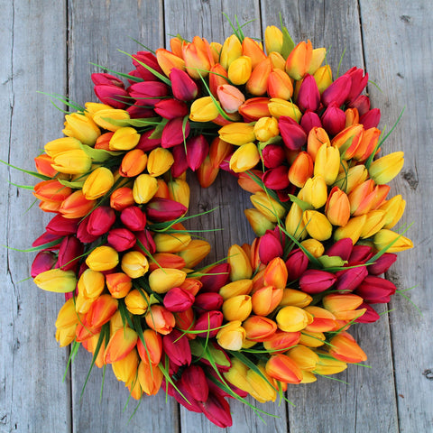 The Wreath Depot blush tulip wreath on a front door with sheltered outdoor display.