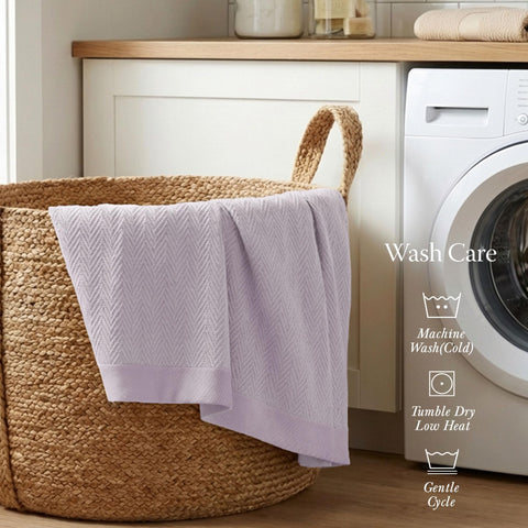 Threadmill king-size blanket on bed demonstrates breathable cotton suitable for warm days.