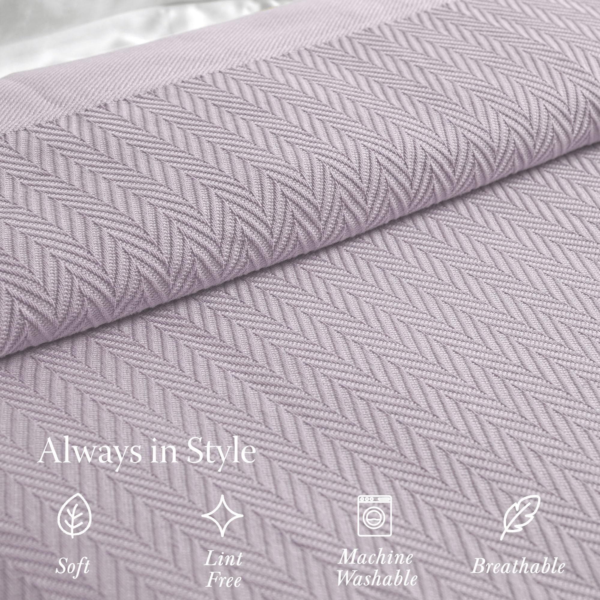 Threadmill all-season blanket shown on couch for universal warmth and style.