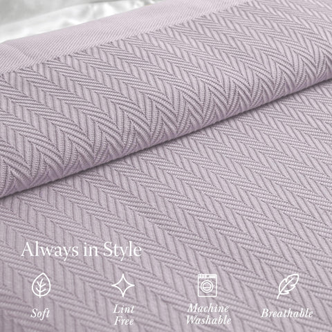 Threadmill all-season blanket shown on couch for universal warmth and style.