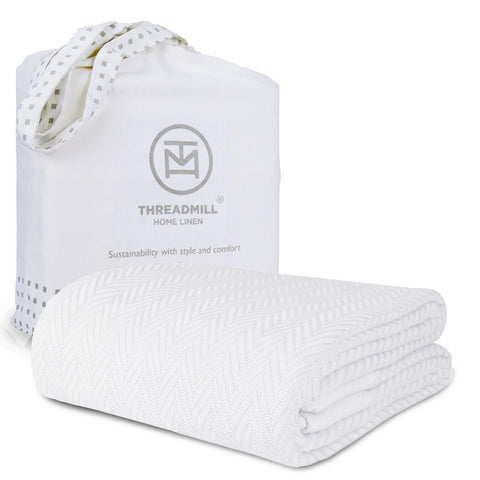 Threadmill luxury cotton blanket with herringbone weave on bed for cozy warmth