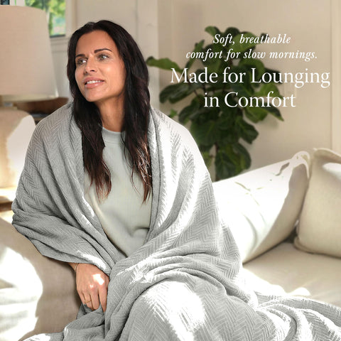 Threadmill light grey blanket draped on a sofa for cozy lounging.