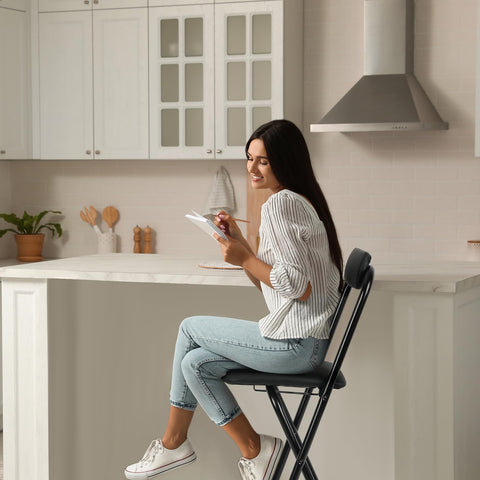 Thyle folding bar stool in dining room setup, versatile seating option.