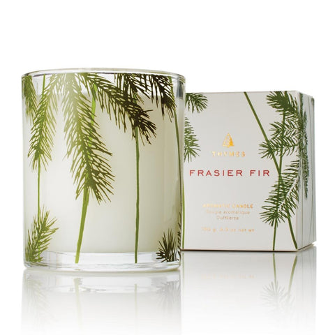 Thymes Frasier Fir candle jar with pine needle motif for seasonal ambiance.
