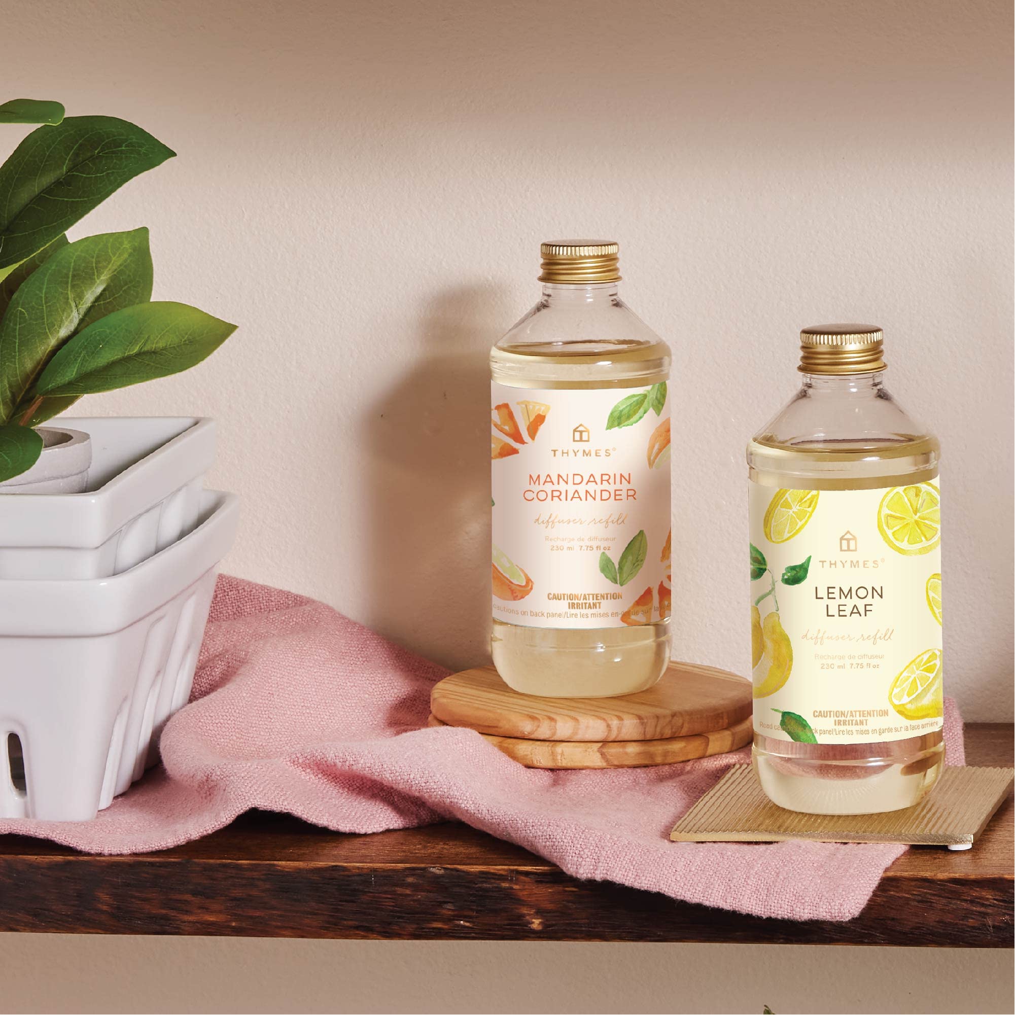Thymes Lemon Leaf oil refill being poured for continuous fragrance renewal.
