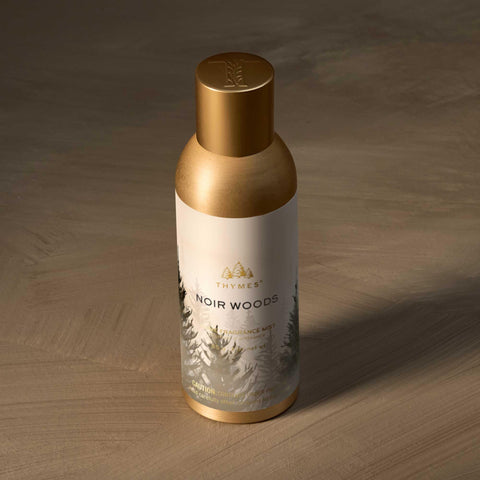 Noir Woods spray in use, enhancing living spaces with evergreen and amber notes.