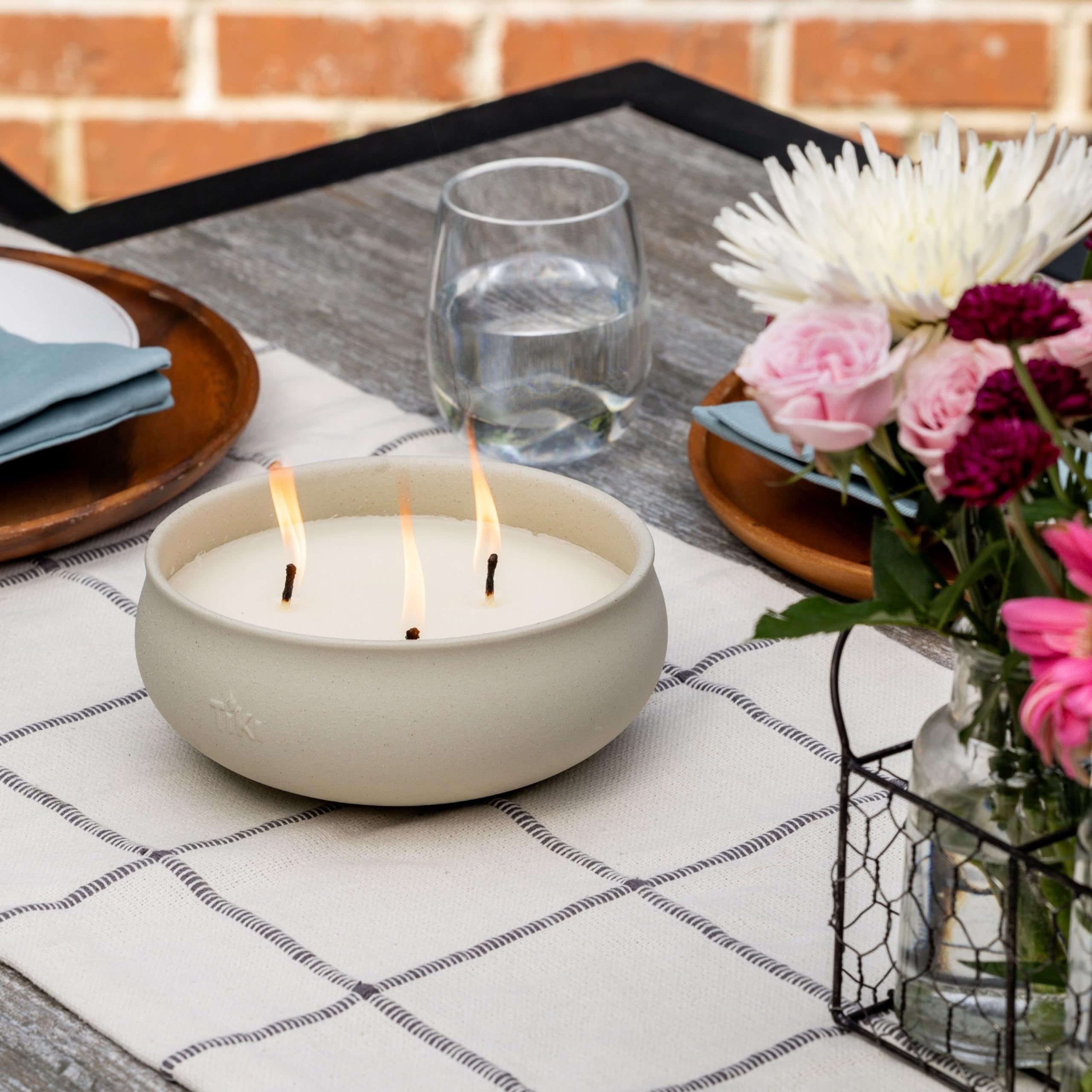 TIKI citronella candle with concrete finish enhances porch decor while offering extended outdoor lighting.