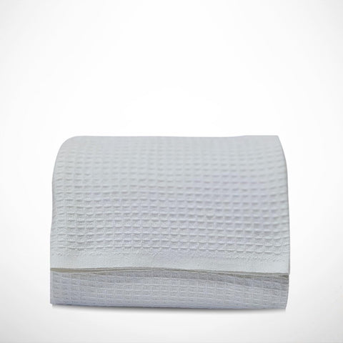 Blanket draped on bed ideal for layering on a queen size bed.