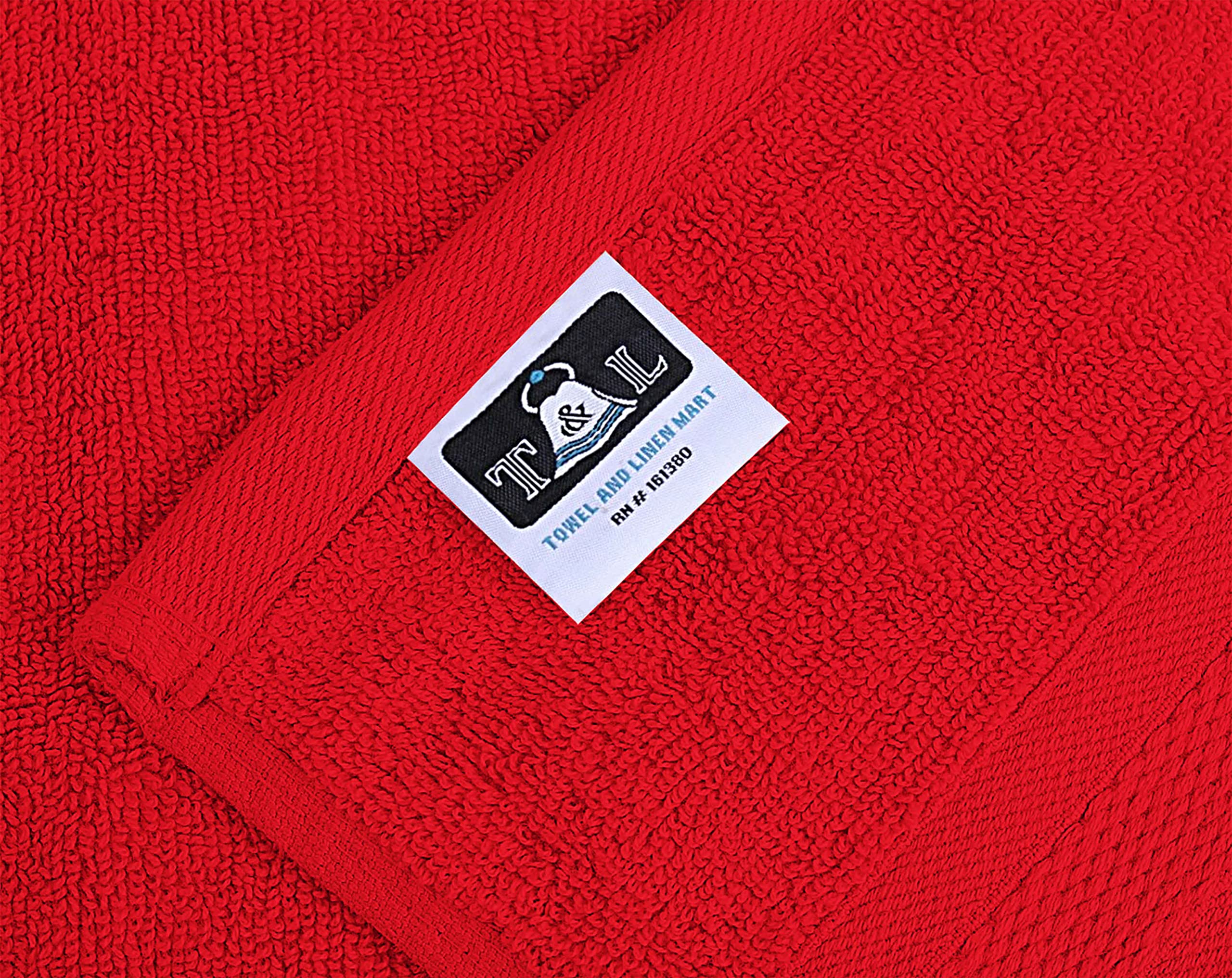 T&L burgundy towels stacked neatly, showing consistent color and premium weave.
