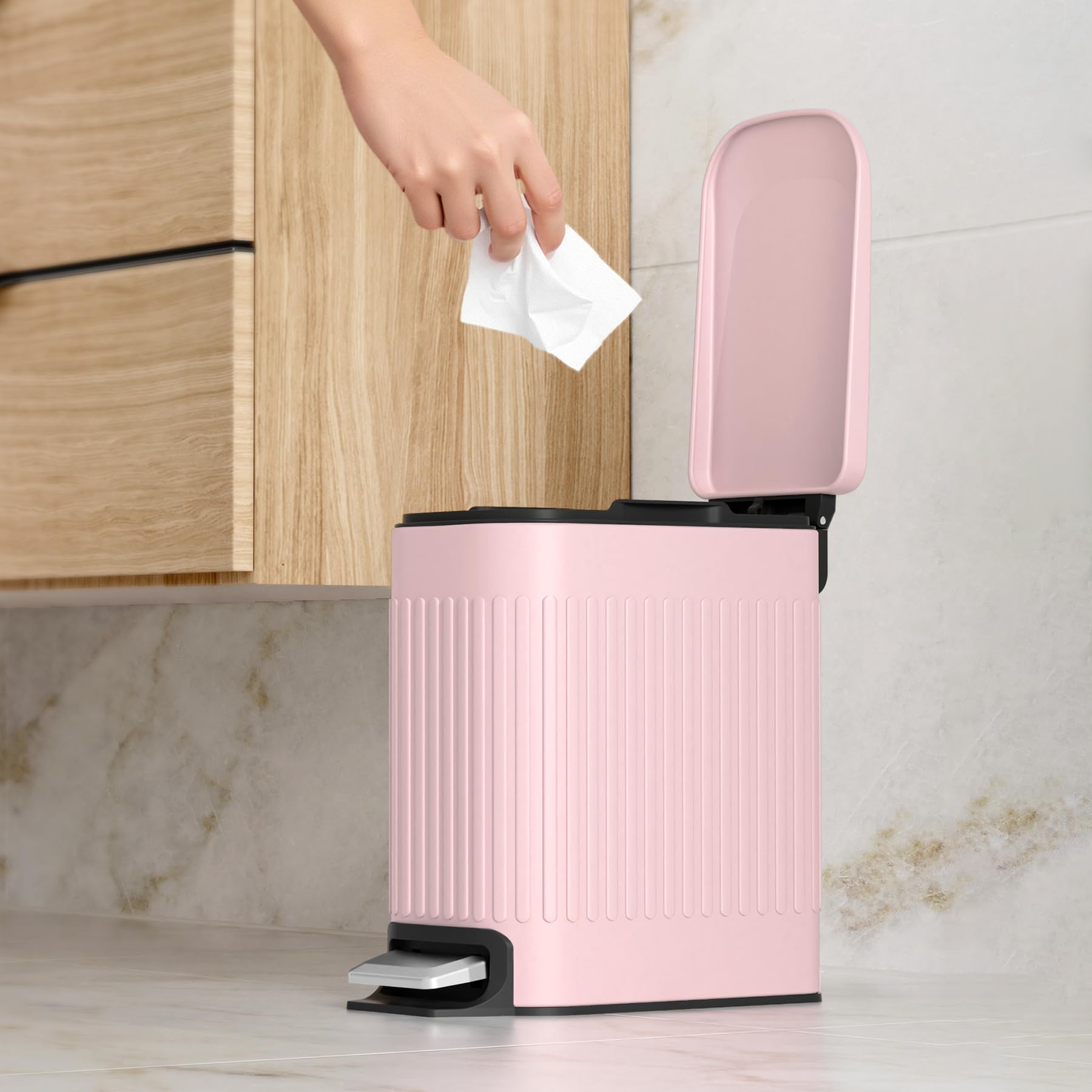 TrashAid pink trash can in office keeps workspace tidy and organized.