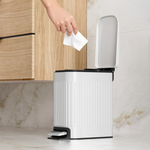 TrashAid step pedal operation for hands-free trash disposal