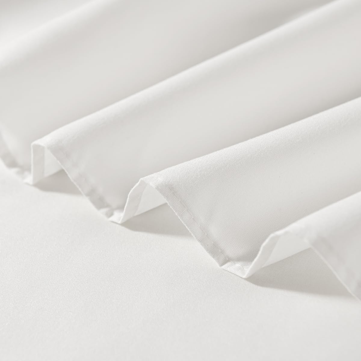 TSUTOMI ivory ruffled edge detail enhances the bed frame.