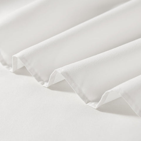 TSUTOMI ivory ruffled edge detail enhances the bed frame.