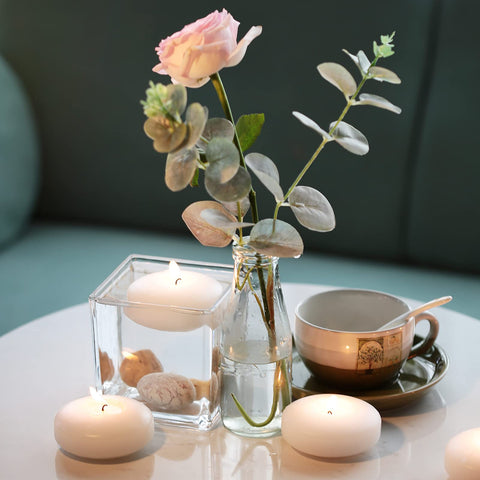 Tuyai floating candles glow softly on outdoor patio for evening ambiance.