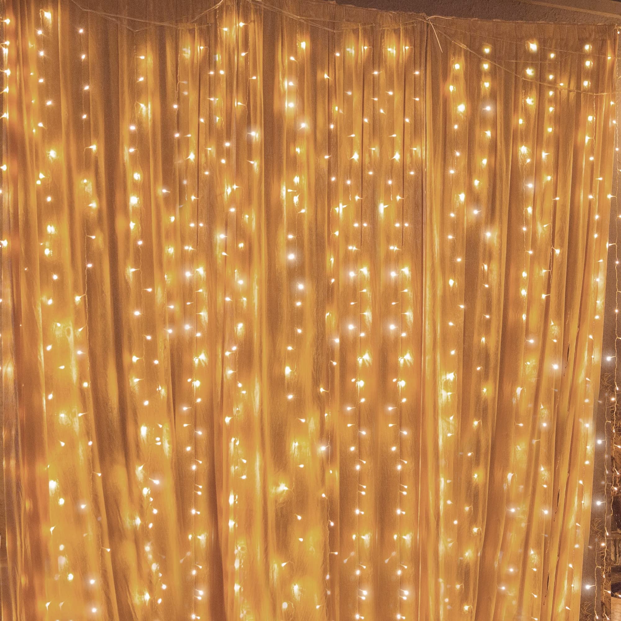 Twinkle Star 300 LED window curtain lights framing a window with a warm glow