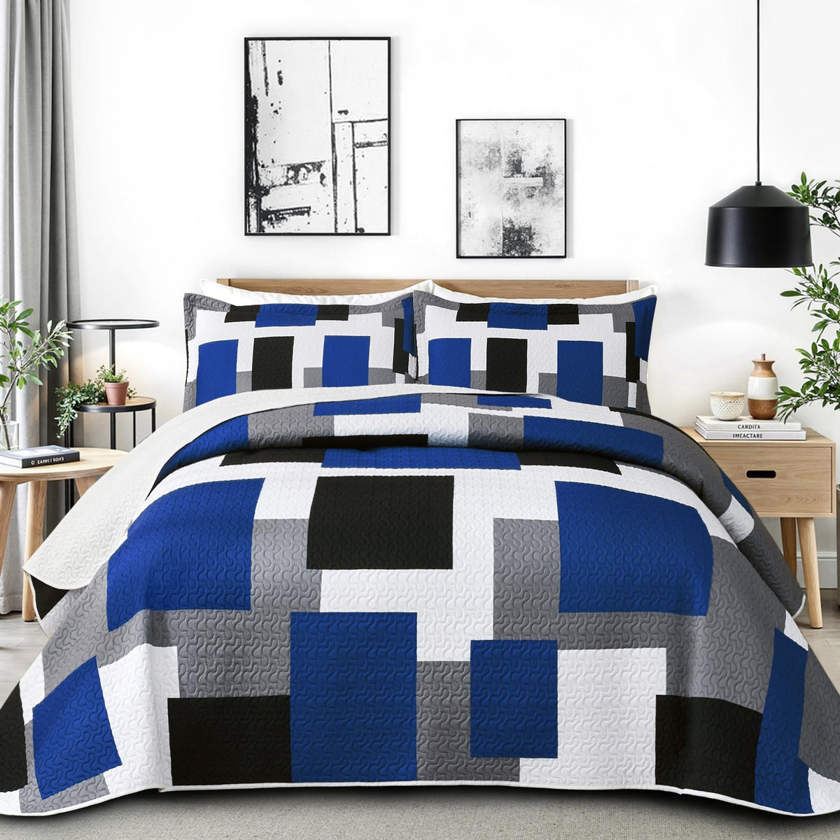 Tyrot patchwork quilt blue white grey adds color and texture to the bed.