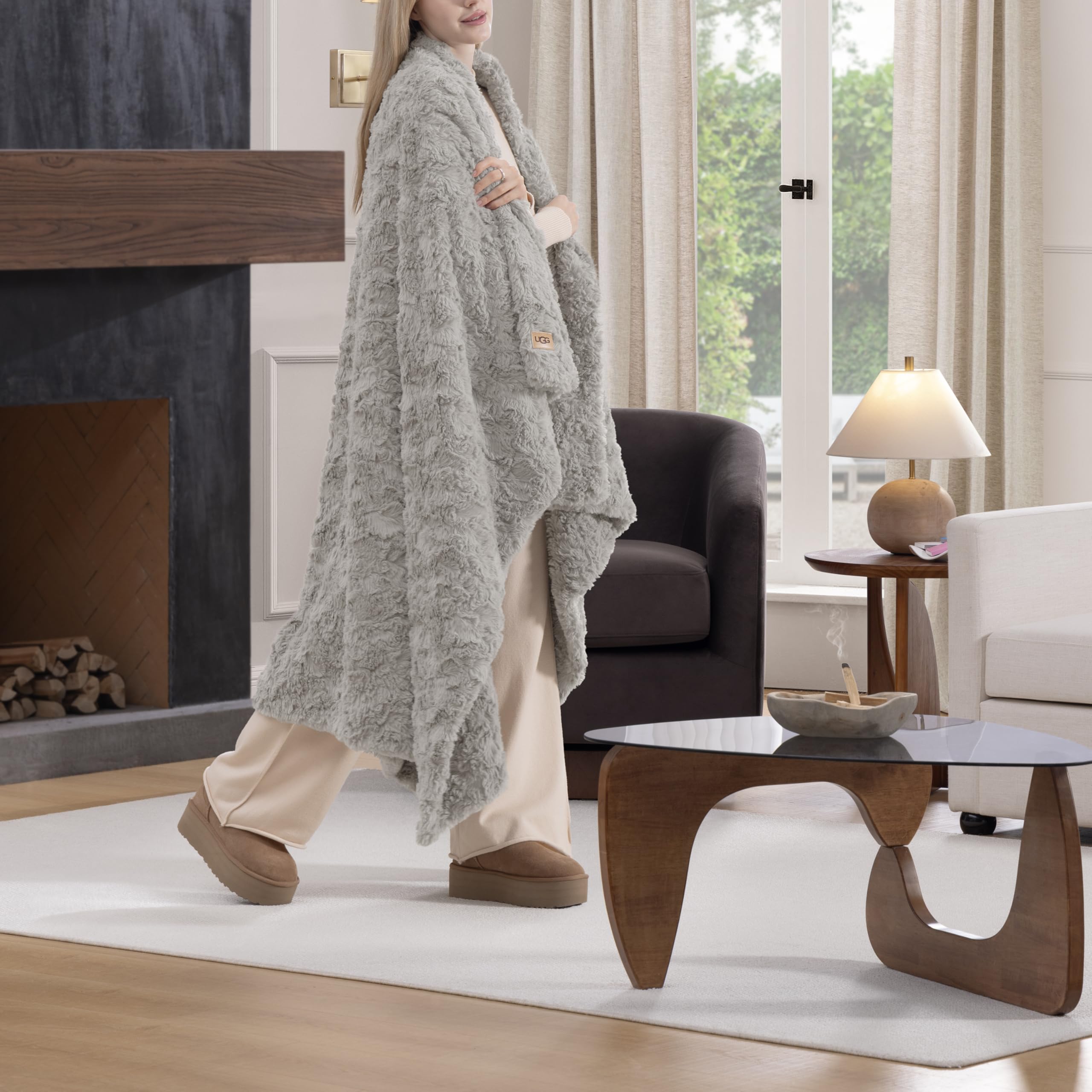 UGG Adalee double-sided faux fur throw showcased as versatile living room accent.