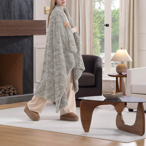 UGG Adalee double-sided faux fur throw showcased as versatile living room accent.