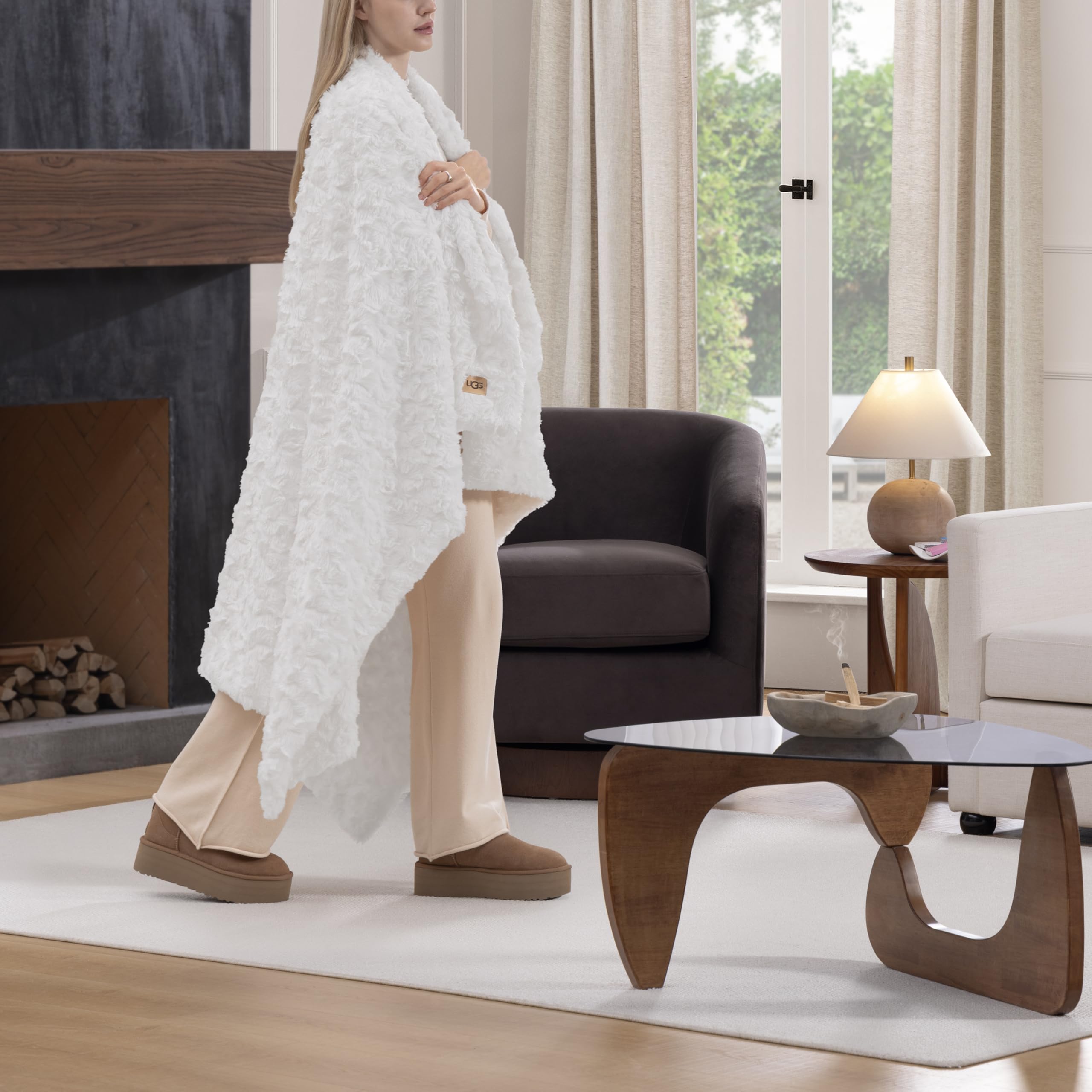 UGG Adalee faux fur throw blanket on couch for cozy living room layering.