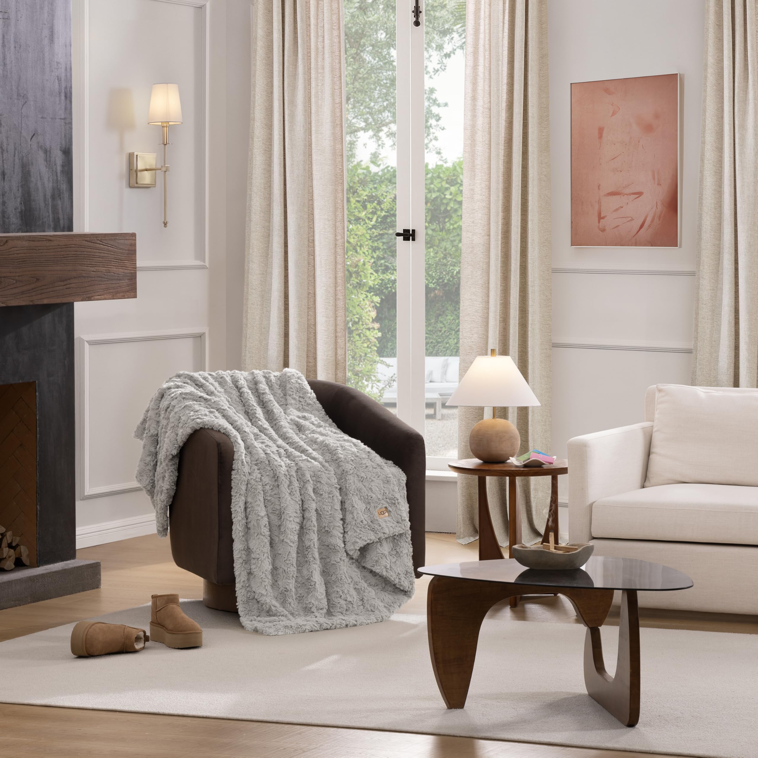 UGG Adalee hypoallergenic faux fur throw on chair offers soft luxury.
