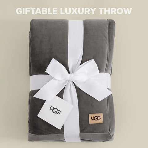 UGG Bliss Throw Blanket 50x70 size displayed on a sofa