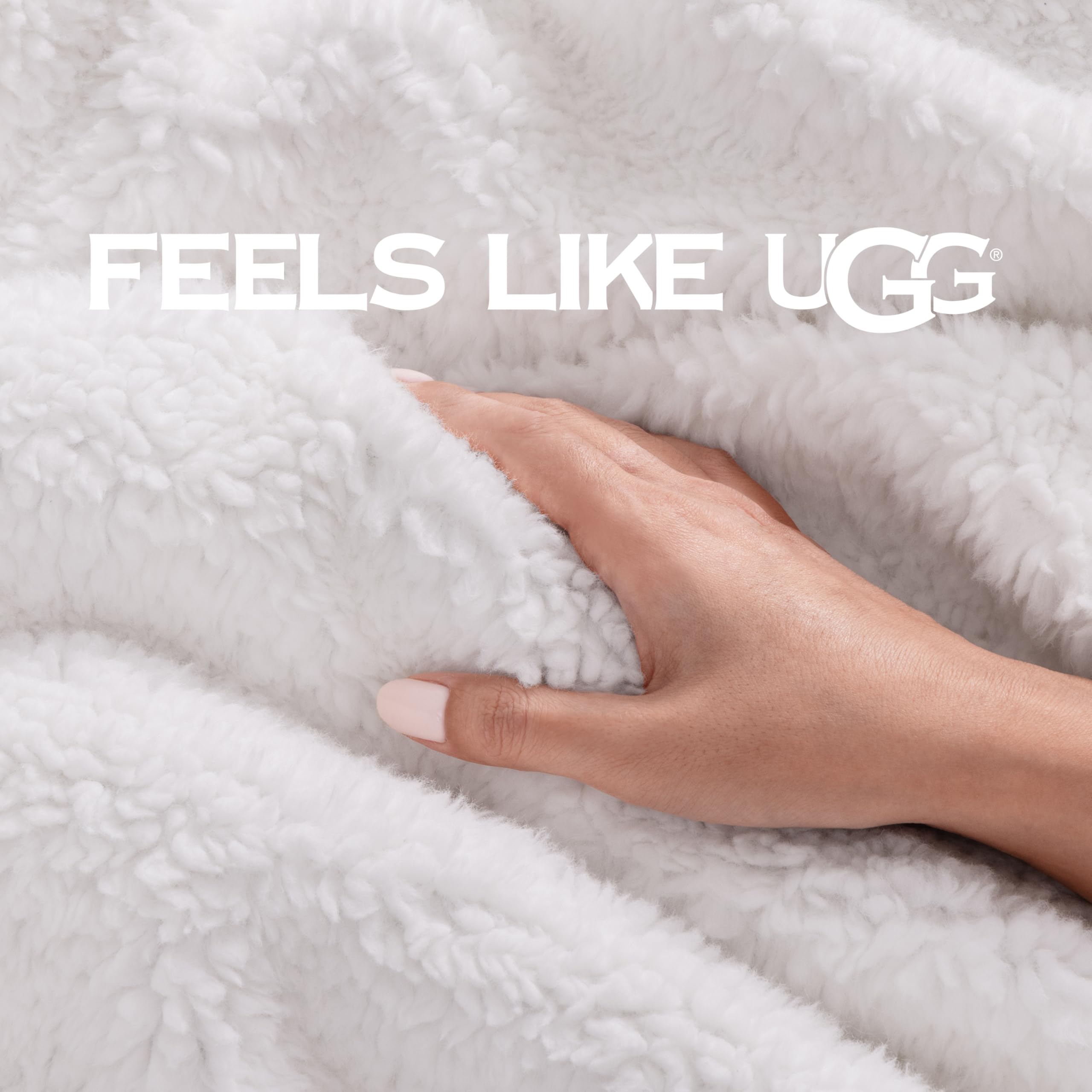UGG Bliss Throw Blanket draped over a couch for warmth